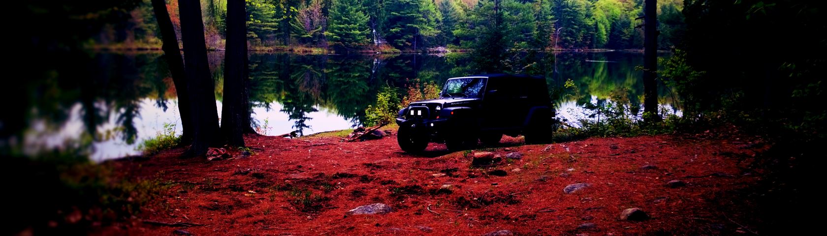 Jeep Rubicon on red lake shore
